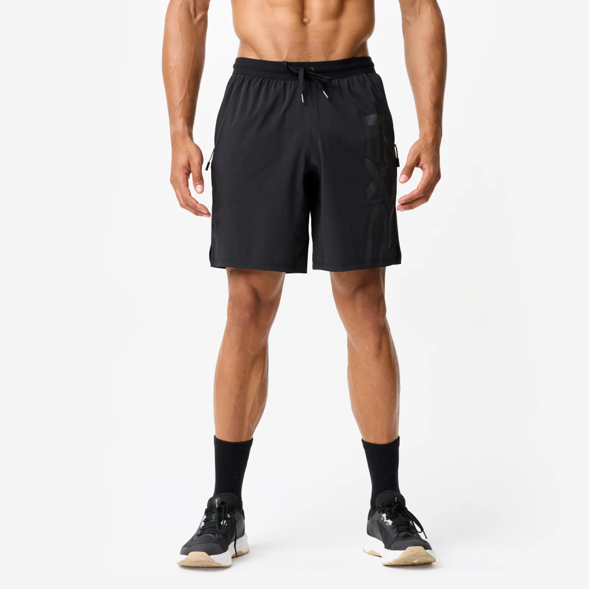 DOMYOS Pánske elastické fitness šortky sivo-čierne M · záber 1